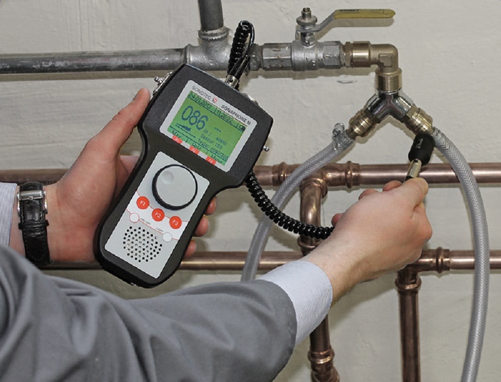 Plumber testing pipes with electronic leak detection equipment in Palm Springs