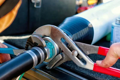 Technician tightening an industrial pipe connection in Palm Springs