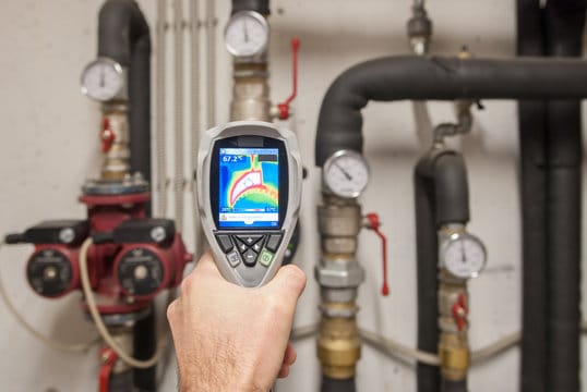 Plumber using a thermal imaging camera to inspect pipes in Palm Springs
