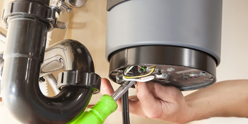 Technician repairing the heating element of a water heater in Palm Springs
