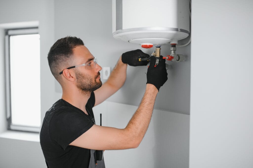 Technician performing water heater maintenance in Palm Springs