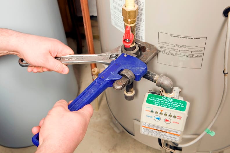 Plumber repairing a water heater valve in Palm Springs
